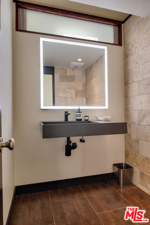9624 Yoakum Drive Beverly Hills, CA 90210 - Photo 11 of 27 a bathroom with a sink and a mirror