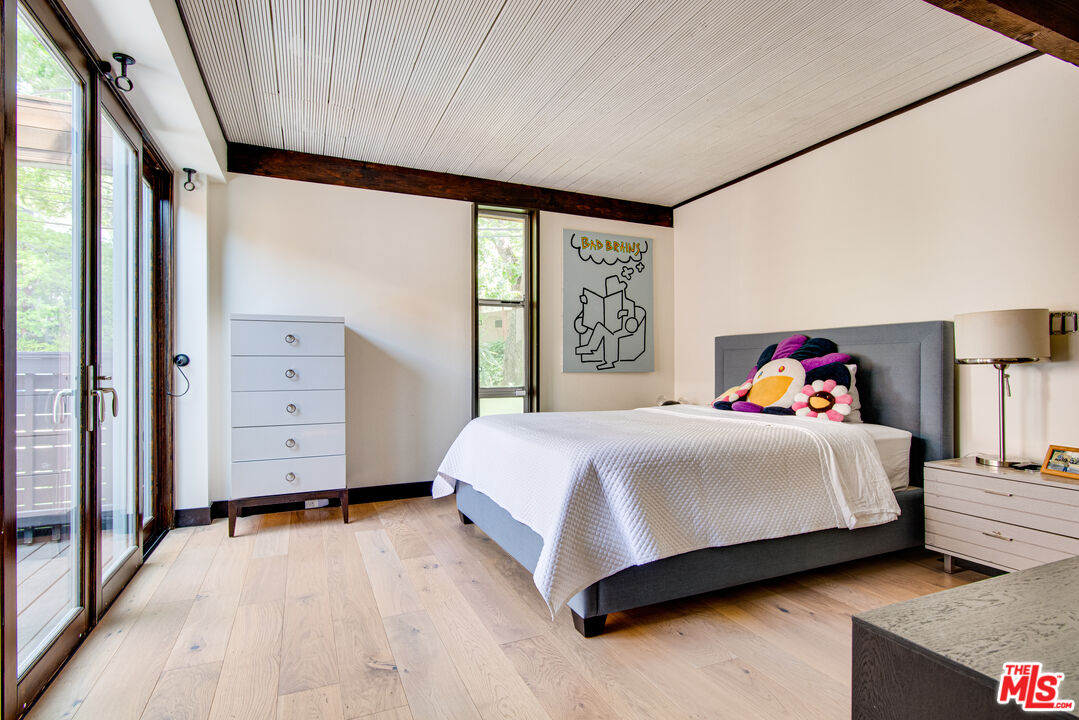 9624 Yoakum Drive Beverly Hills, CA 90210 - Photo 12 of 27 a spacious bedroom with a bed and a window
