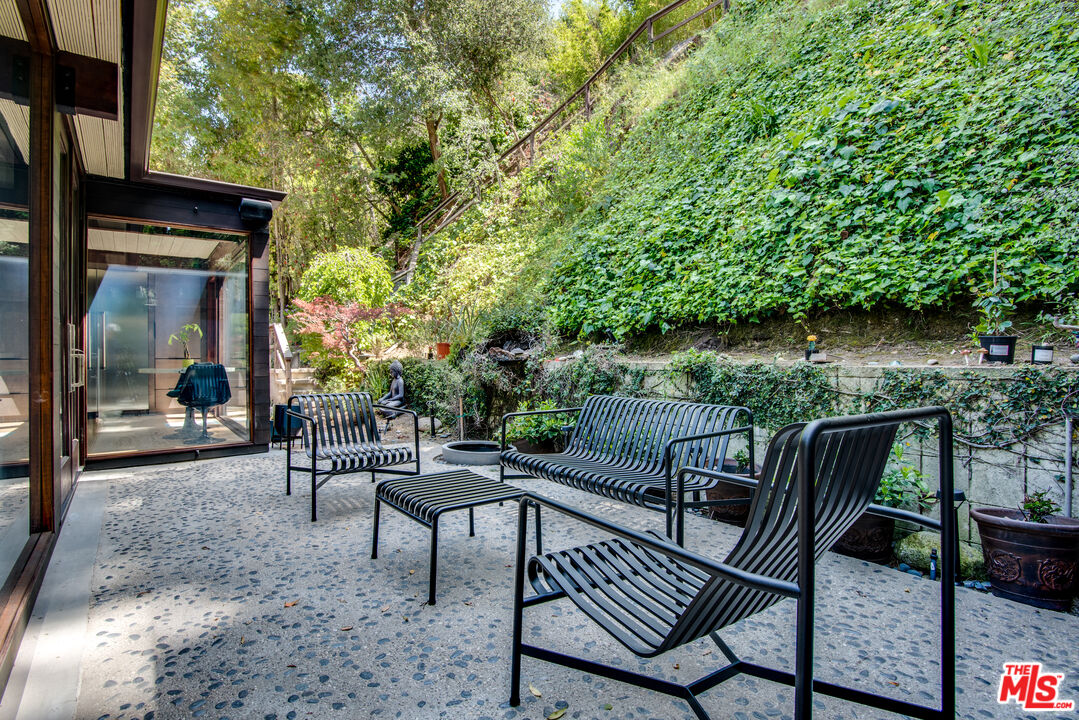 9624 Yoakum Drive Beverly Hills, CA 90210 - Photo 21 of 27 a view of a chairs and table in the patio