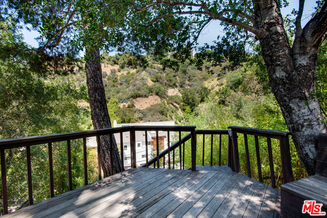 9624 Yoakum Drive Beverly Hills, CA 90210 - Photo 23 of 27 a view of balcony with wooden floor and fence