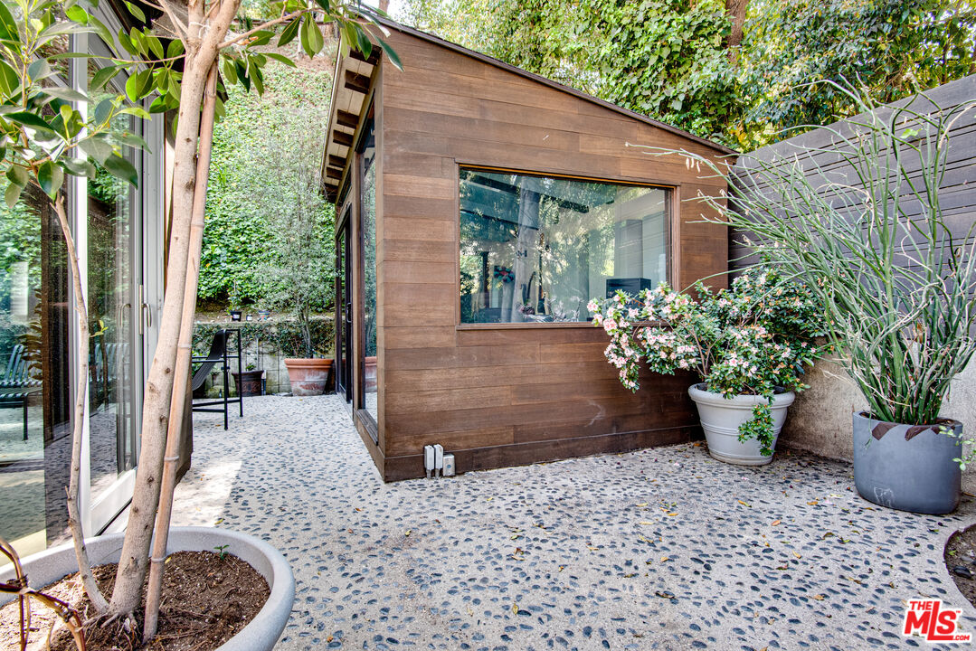 9624 Yoakum Drive Beverly Hills, CA 90210 - Photo 24 of 27 a view of a backyard with potted plants