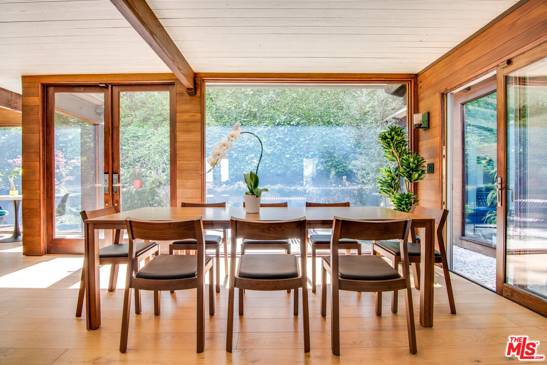 9624 Yoakum Drive Beverly Hills, CA 90210 - Photo 5 of 27 a dining room with furniture a chandelier and wooden floor
