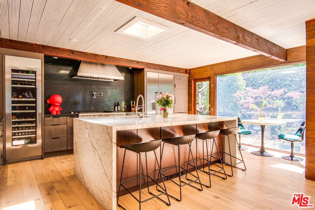 9624 Yoakum Drive Beverly Hills, CA 90210 - Photo 8 of 27 a dining hall with furniture and a large window