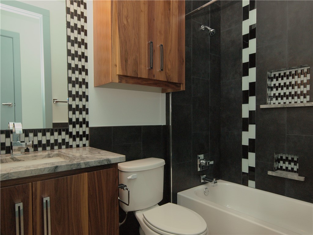 306 Franklin Boulevard, Unit A Austin, TX 78751 - Photo 12 of 19 a bathroom with a sink toilet and shower