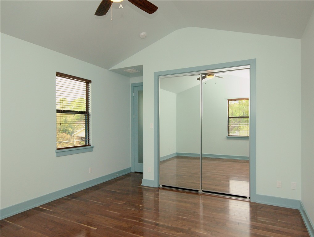 306 Franklin Boulevard, Unit A Austin, TX 78751 - Photo 13 of 19 a view of an empty room with wooden floor and a window