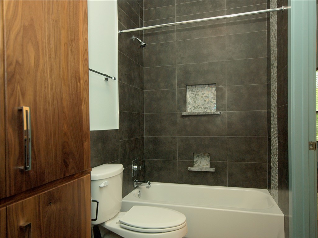 306 Franklin Boulevard, Unit A Austin, TX 78751 - Photo 15 of 19 a bathroom with a toilet and shower