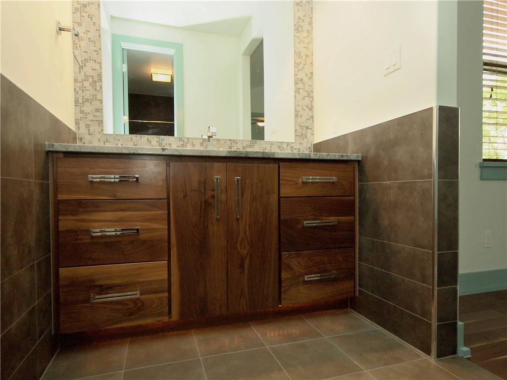 306 Franklin Boulevard, Unit A Austin, TX 78751 - Photo 16 of 19 a bathroom with a granite countertop sink and a mirror