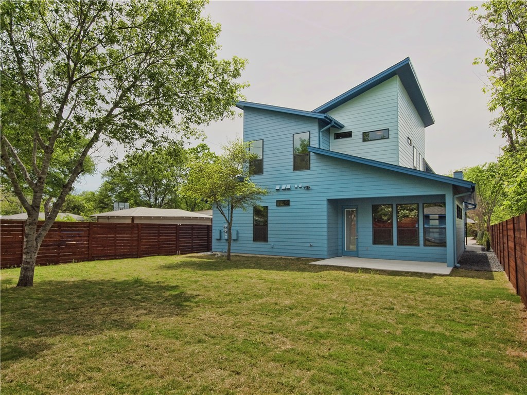 306 Franklin Boulevard, Unit A Austin, TX 78751 - Photo 18 of 19 a front view of house with yard and trees in the background