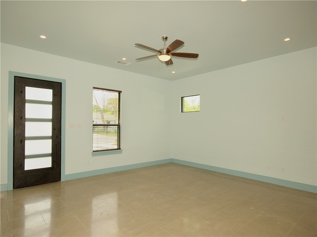 306 Franklin Boulevard, Unit A Austin, TX 78751 - Photo 4 of 19 an empty room with windows and ceiling fan