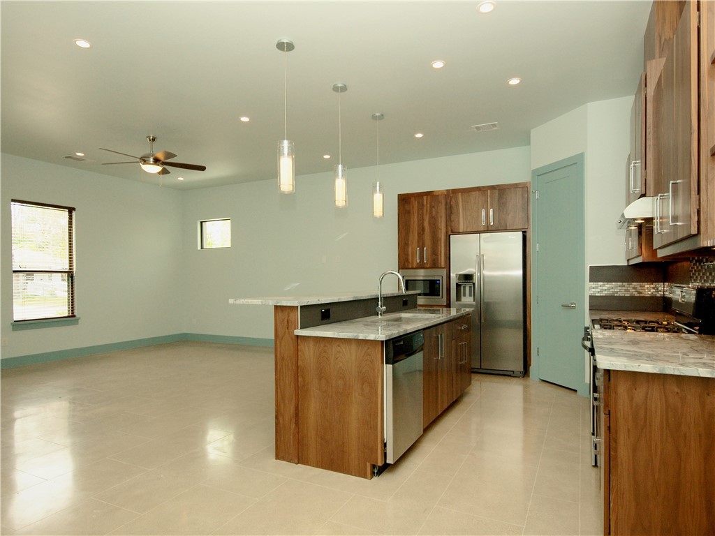 306 Franklin Boulevard, Unit A Austin, TX 78751 - Photo 5 of 19 a kitchen with stainless steel appliances granite countertop a stove a sink and a refrigerator