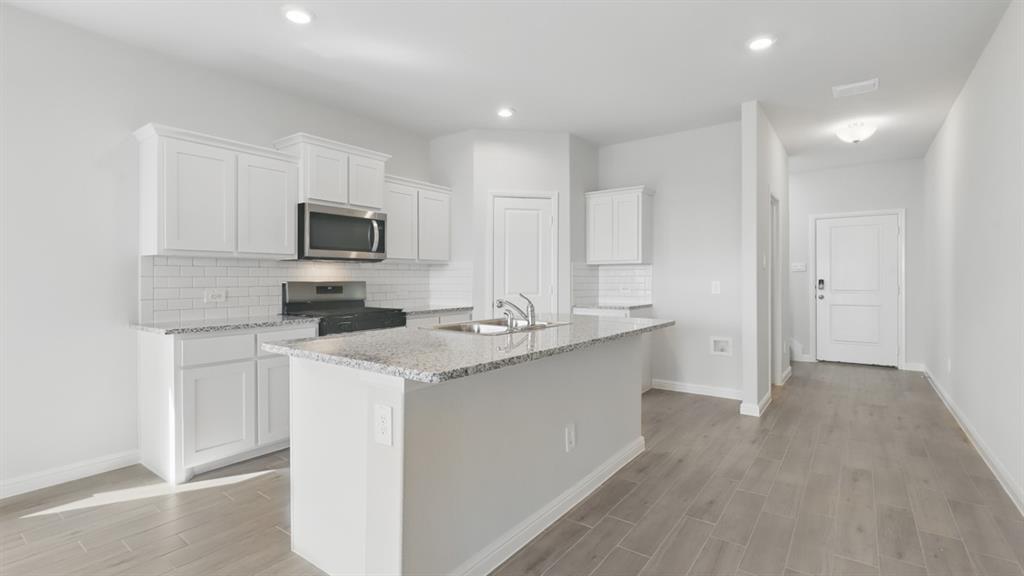 1202 Rockwater Drive Decatur, TX 76234 - Photo 38 of 40 Kitchen-All Home and community information, including pricing, included features, terms, availability and amenities, are subject to change at any time without notice or obligation. All Drawings, pictures, photographs, video, square footages, floor plans, elevations, features, colors and sizes are approximate for illustration purposes only and will vary from the homes as built.