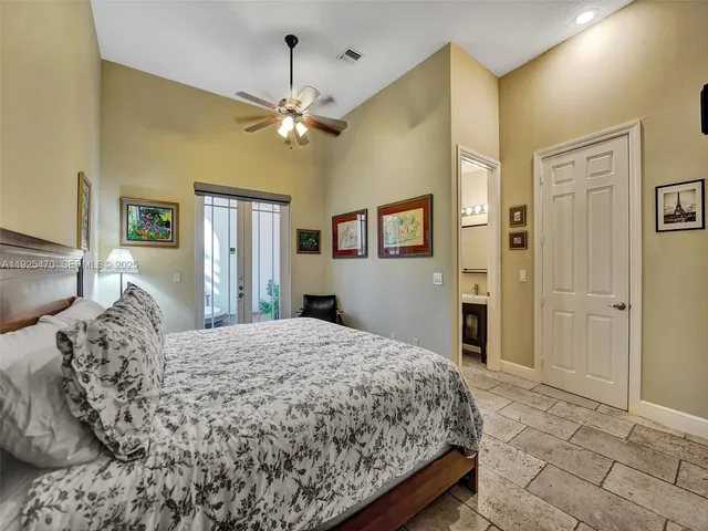 a living room with furniture two window and a chandelier