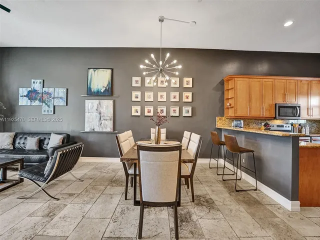 a kitchen with granite countertop a refrigerator sink and microwave