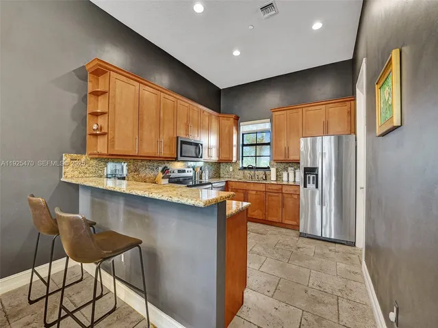 a spacious bedroom with a bed and a flat screen tv