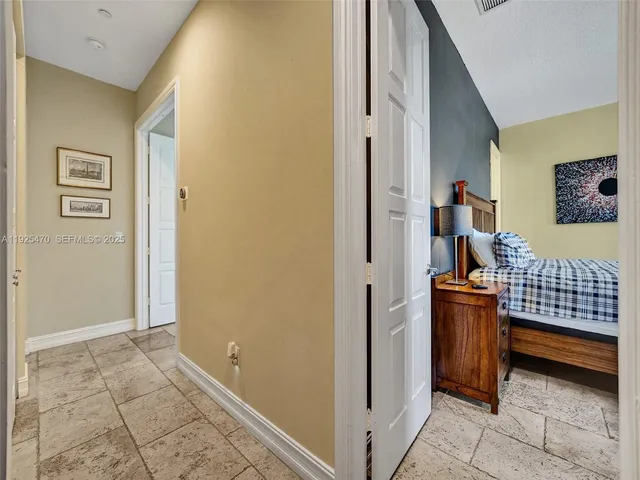 a view of a hallway with couches and painted walls