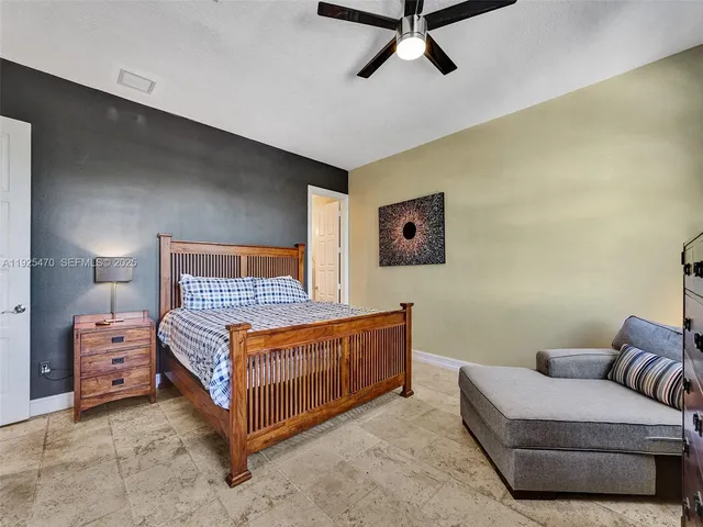 a view of a patio with table and chairs and potted plants
