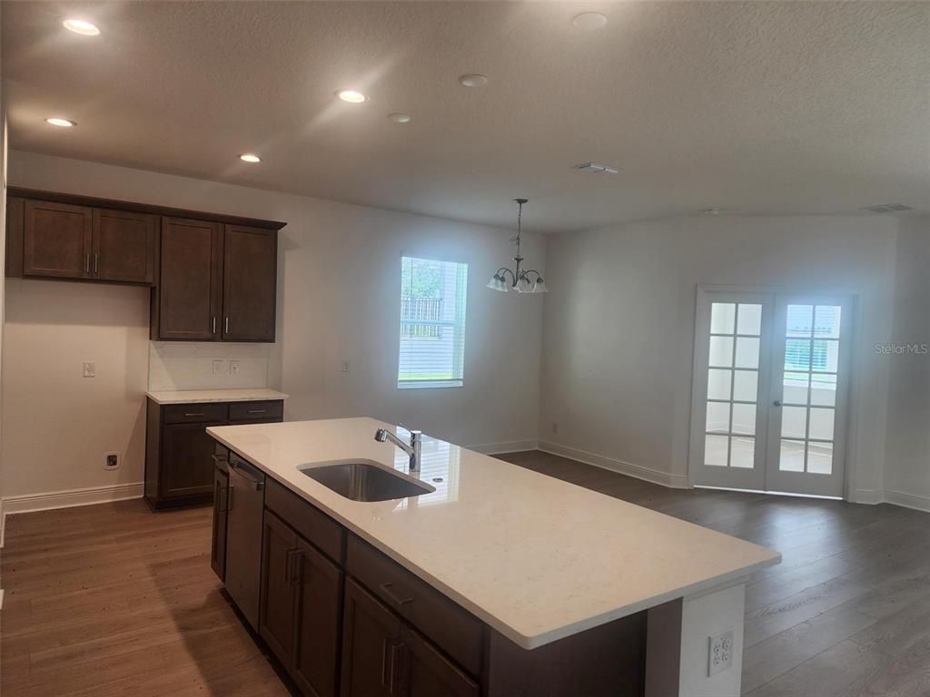 7501 Catania Loop Clermont, FL 34714 - Photo 5 of 12 a kitchen with a sink a stove and cabinets