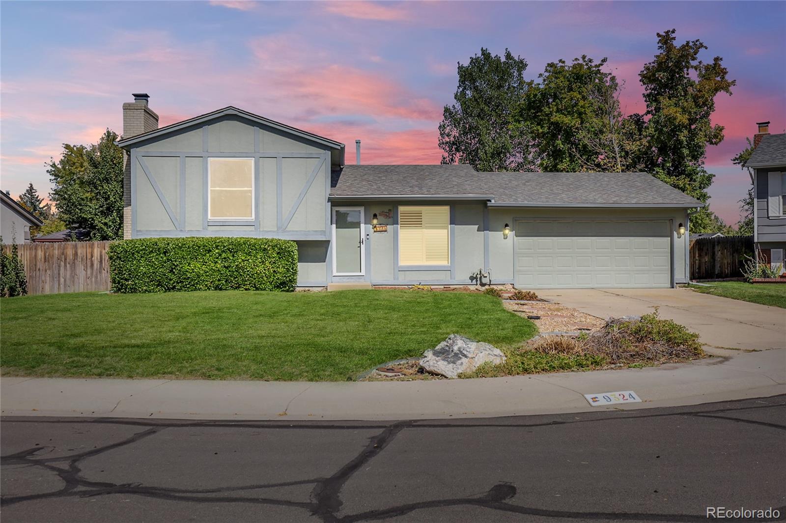 9324 Field Lane Broomfield, CO 80021 - Photo 2 of 43 a front view of a house with a yard and garage