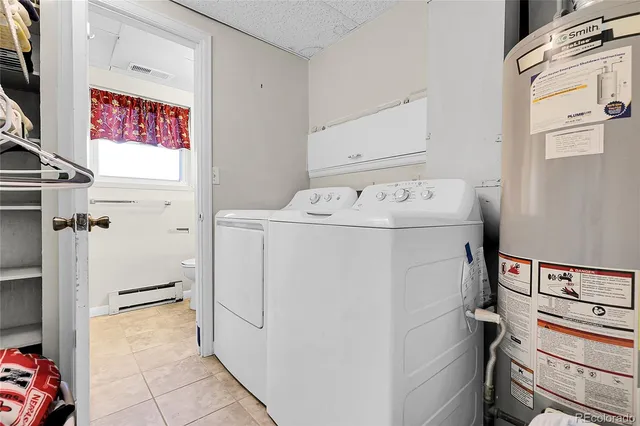 a view of a white house with a yard and potted plants