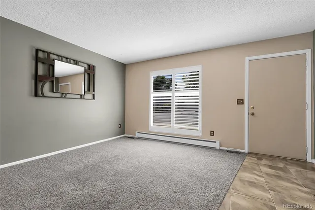 a kitchen with stainless steel appliances granite countertop a refrigerator a stove and a sink with wooden floor