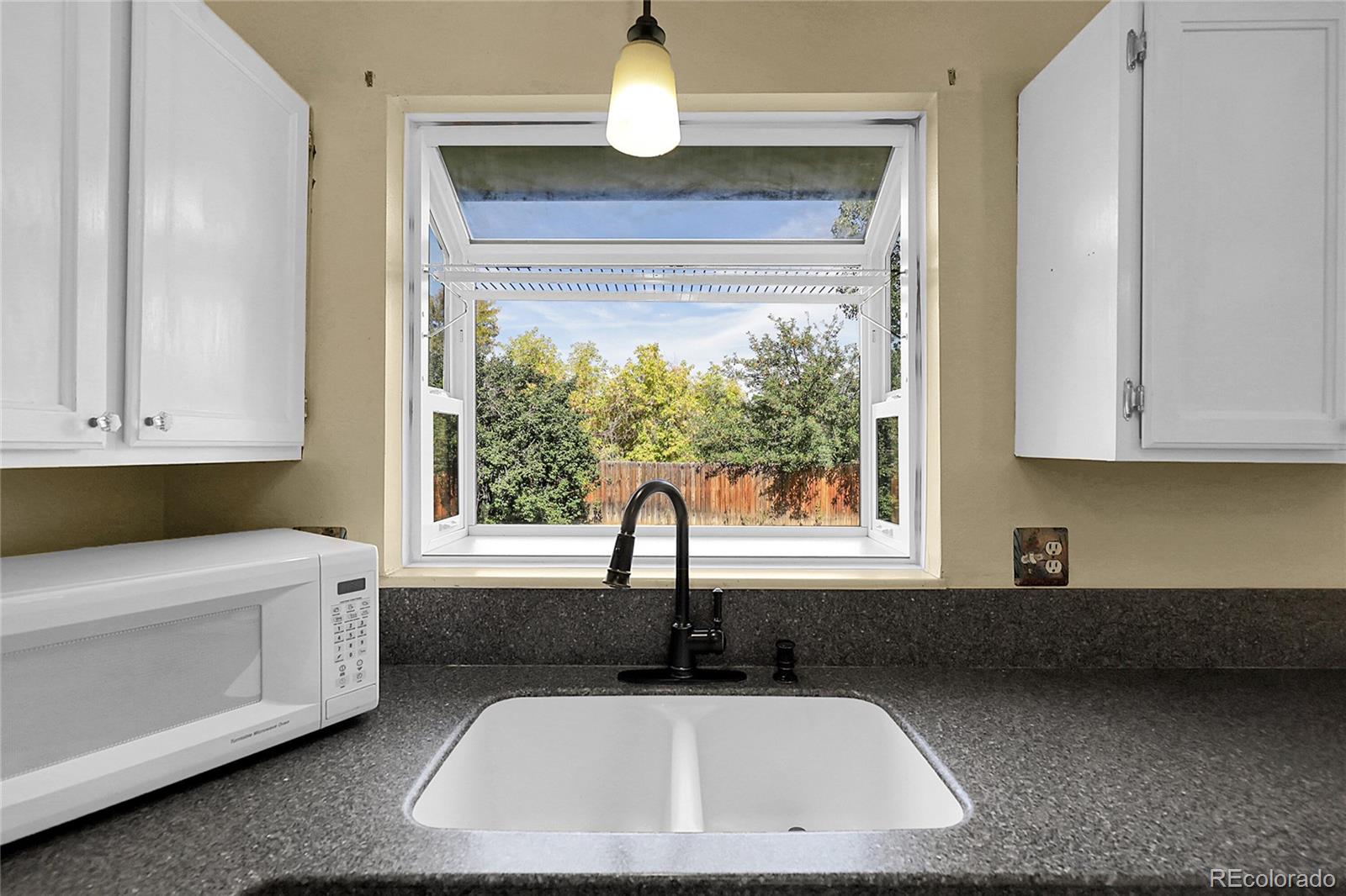 9324 Field Lane Broomfield, CO 80021 - Photo 8 of 43 a kitchen with a sink and a window