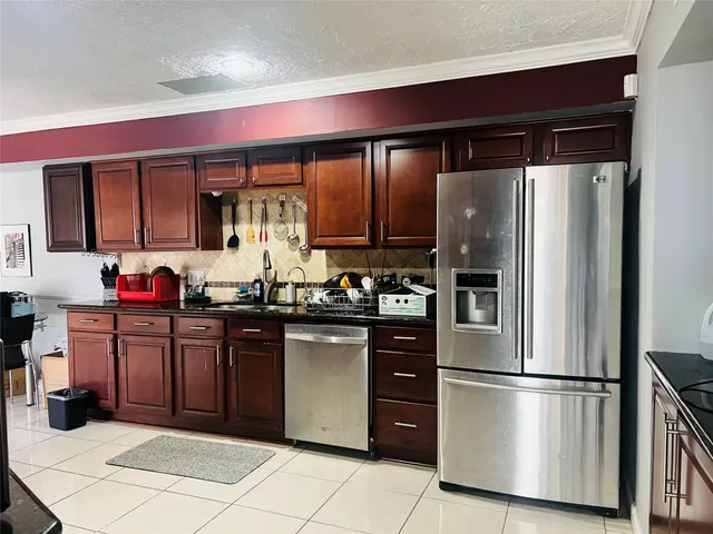 a living room with furniture and wall paintings