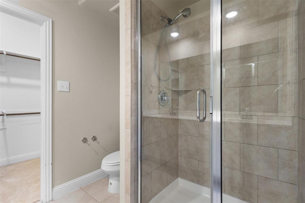 2900 Country Church Road McKinney, TX 75071 - Photo 17 of 40 a bathroom with a granite countertop bathtub shower and toilet