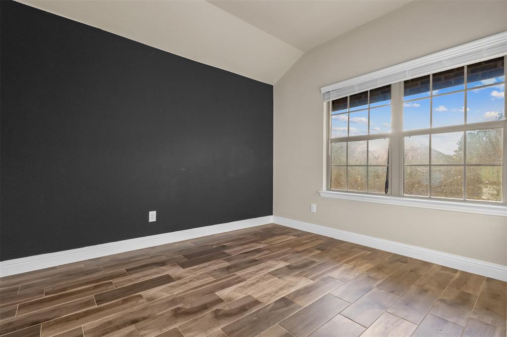 2900 Country Church Road McKinney, TX 75071 - Photo 19 of 40 an empty room with wooden floor and windows