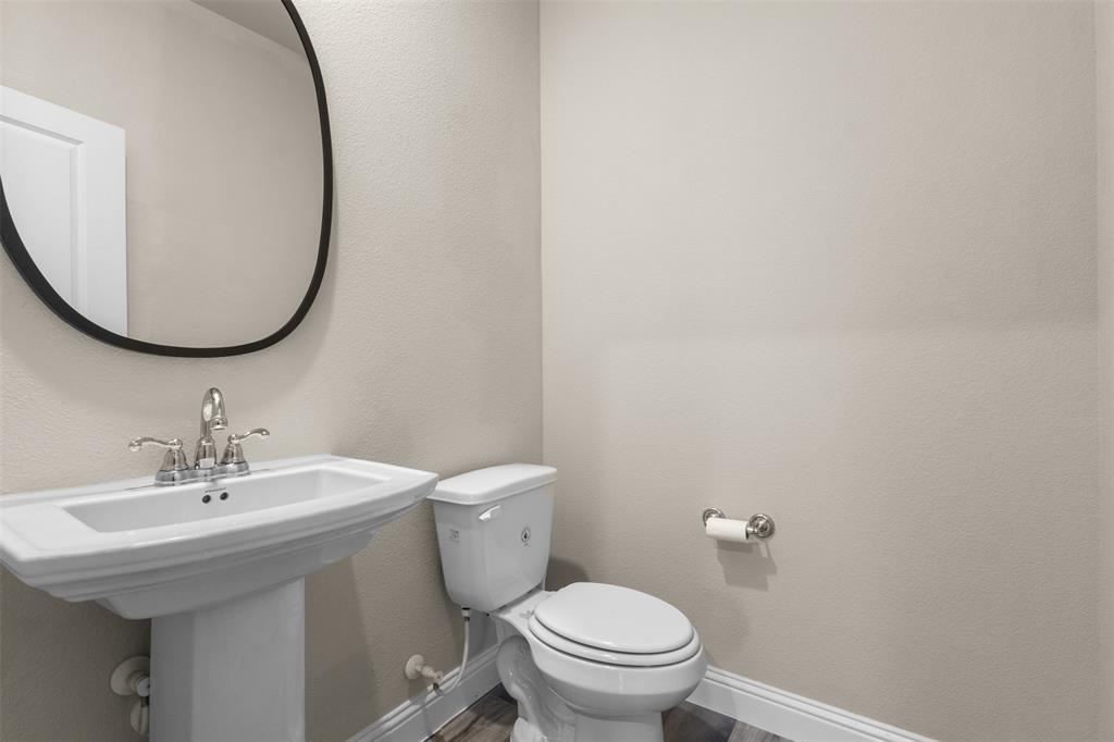 2900 Country Church Road McKinney, TX 75071 - Photo 21 of 40 a bathroom with a sink a toilet and a mirror