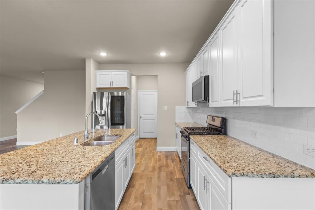 2900 Country Church Road McKinney, TX 75071 - Photo 9 of 40 a kitchen with granite countertop counter top space a sink stainless steel appliances and cabinets