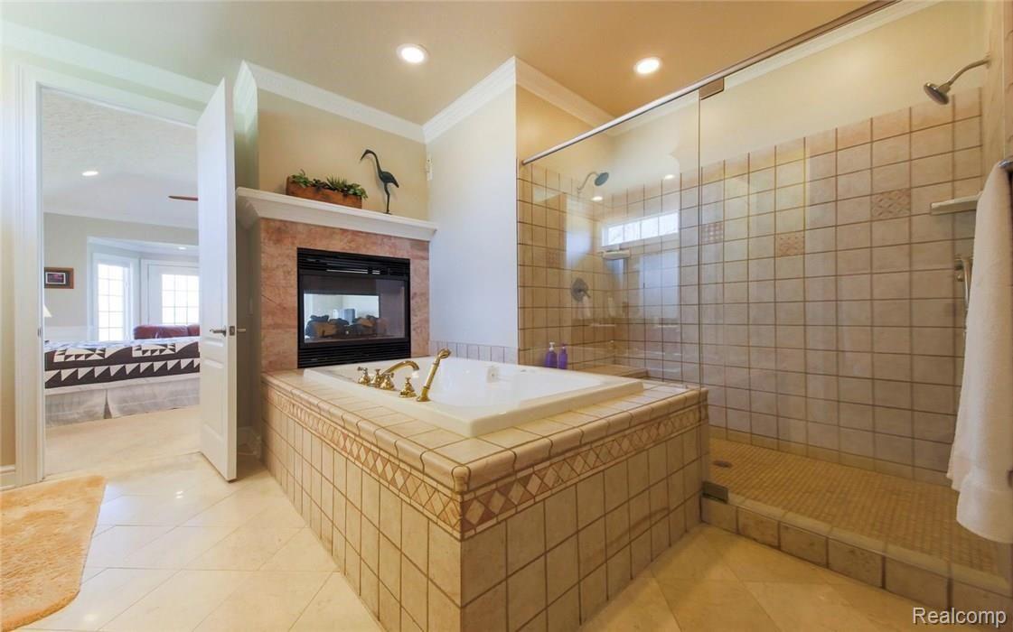 7990 Antcliff Road Howell, MI 48855 - Photo 22 of 51 Jetted tub, enormous shower, dual sided fireplace.