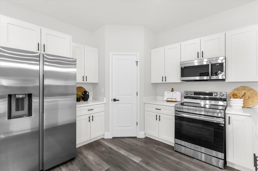 4535 Southwest 172nd Street Road Ocala, FL 34473 - Photo 13 of 35 a kitchen with stainless steel appliances a stove a sink and a refrigerator