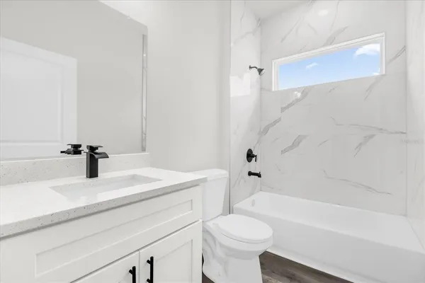 a bathroom with a sink a toilet and a bathtub