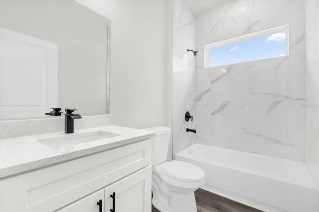 a bathroom with a sink a toilet and a bathtub