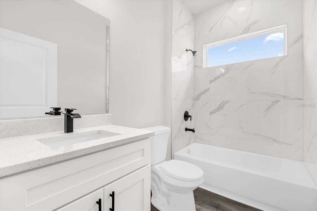 4535 Southwest 172nd Street Road Ocala, FL 34473 - Photo 21 of 35 a bathroom with a sink a toilet and a bathtub