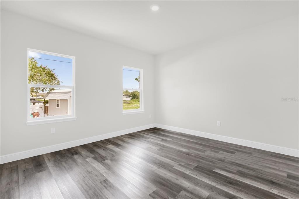 4535 Southwest 172nd Street Road Ocala, FL 34473 - Photo 24 of 35 an empty room with wooden floor and window