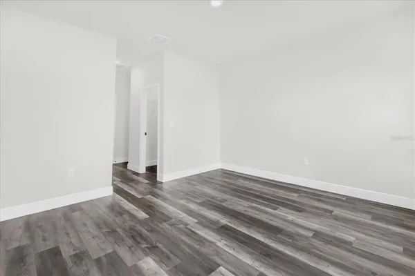 a view of wooden floor and closet in a room