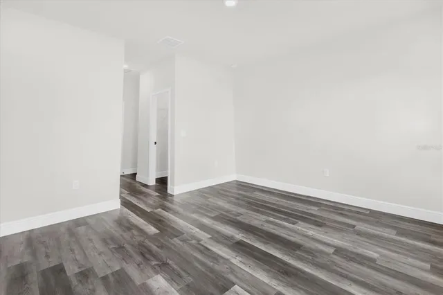 a view of wooden floor and closet in a room