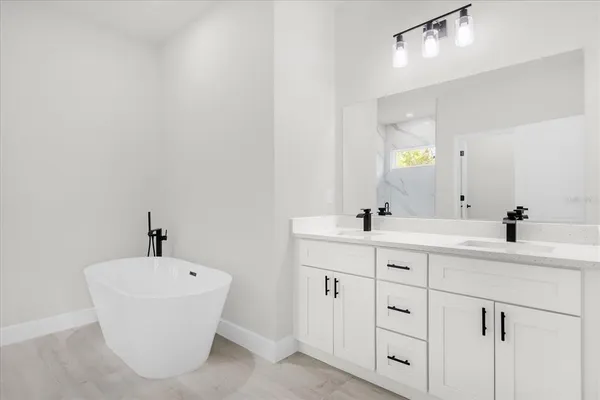 a bathroom with a double vanity sink and a mirror