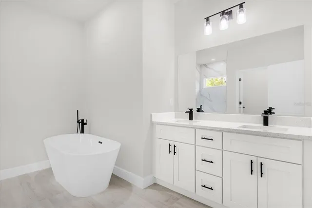a bathroom with a double vanity sink and a mirror