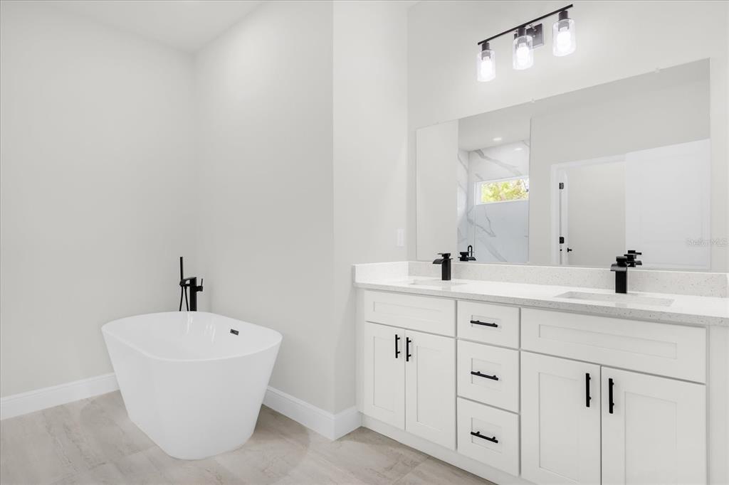 4535 Southwest 172nd Street Road Ocala, FL 34473 - Photo 27 of 35 a bathroom with a double vanity sink and a mirror