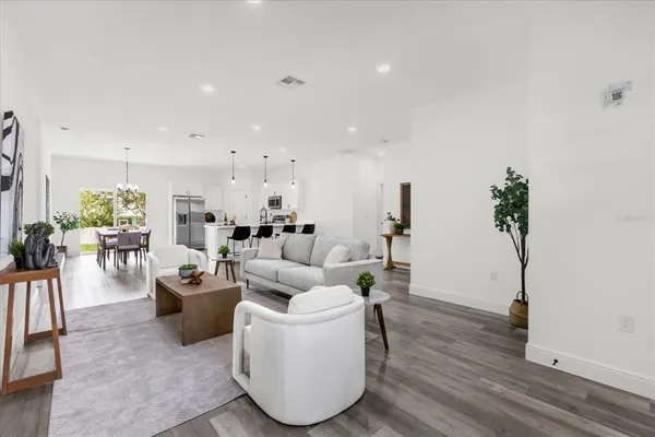 a living room with furniture and a wooden floor
