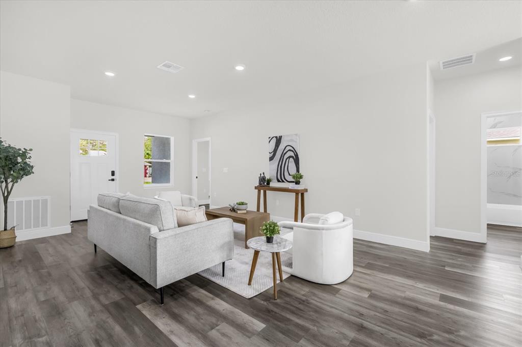 4535 Southwest 172nd Street Road Ocala, FL 34473 - Photo 5 of 35 a living room with furniture and a wooden floor