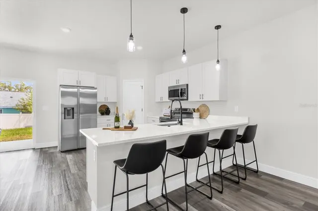 a kitchen with stainless steel appliances kitchen island a large island in the center