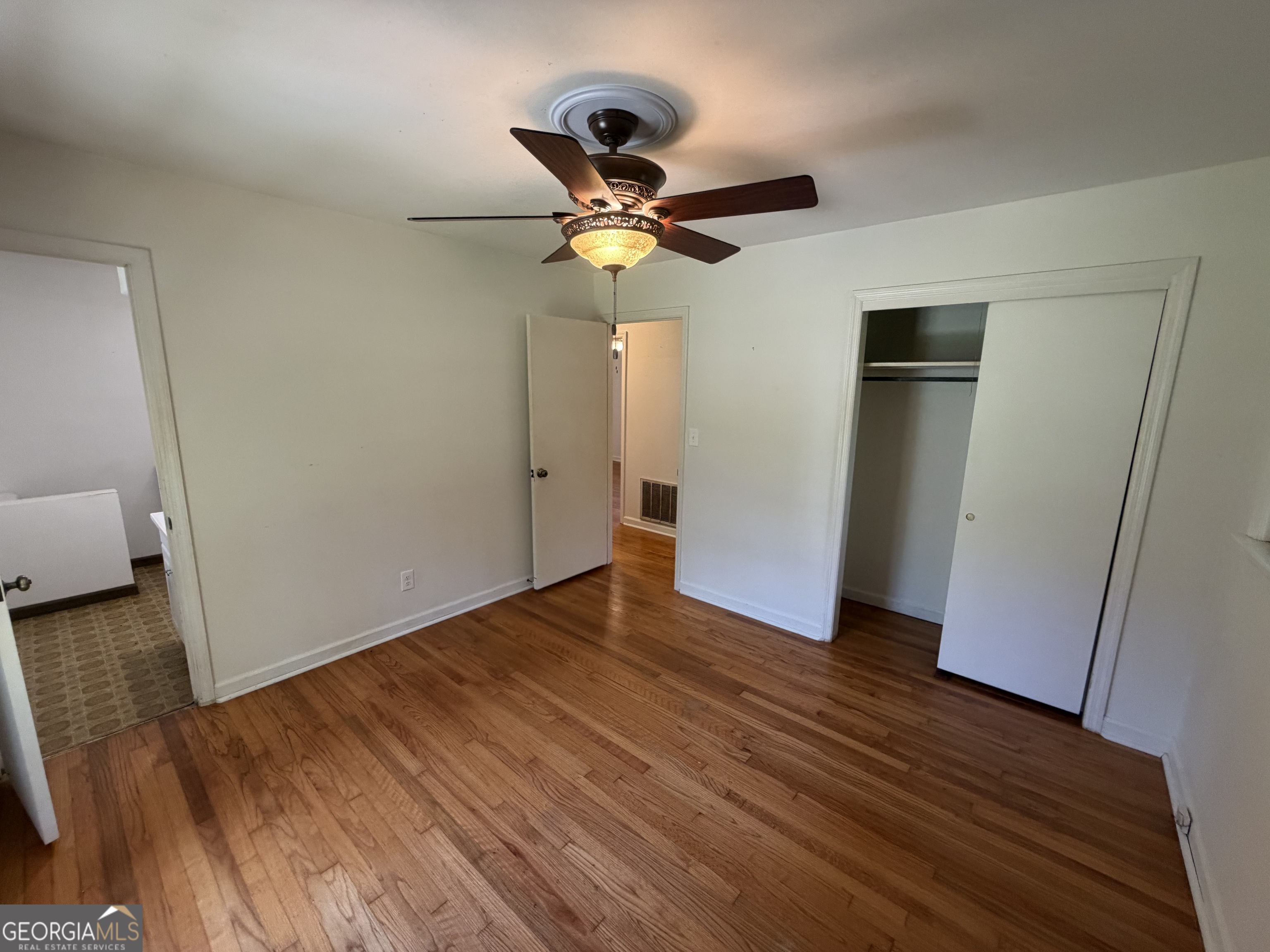 1005 North 1st Street Fort Valley, GA 31030 - Photo 19 of 28 a view of empty room with wooden floor