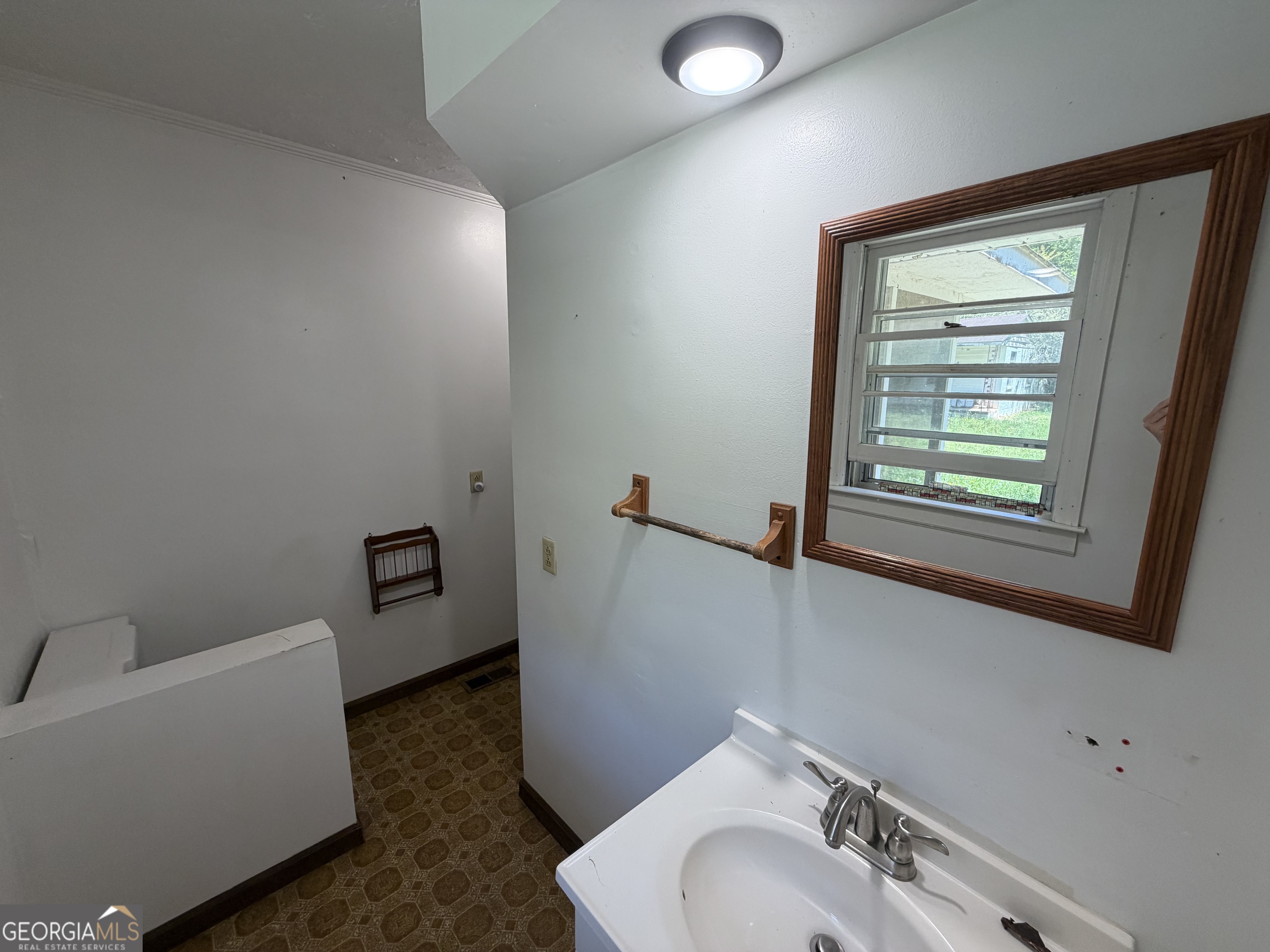 1005 North 1st Street Fort Valley, GA 31030 - Photo 20 of 28 a bathroom with a sink and a mirror