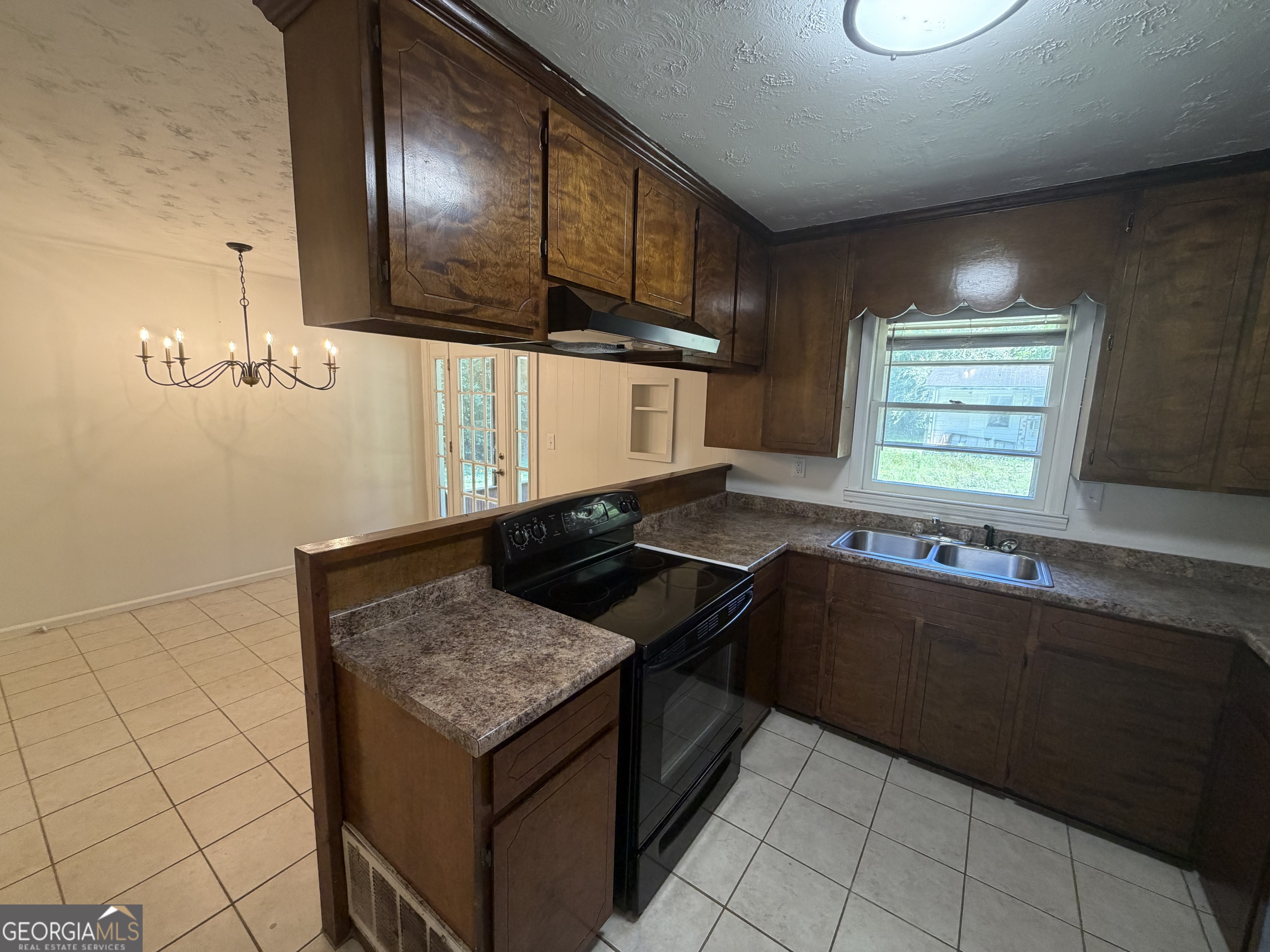 1005 North 1st Street Fort Valley, GA 31030 - Photo 8 of 28 a kitchen with a stove and a sink