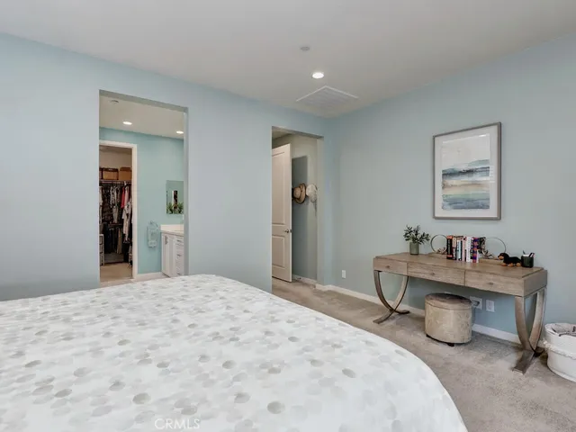 a spacious en suite bathroom with a double sink and mirror