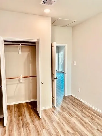 a view of a room with wooden floor