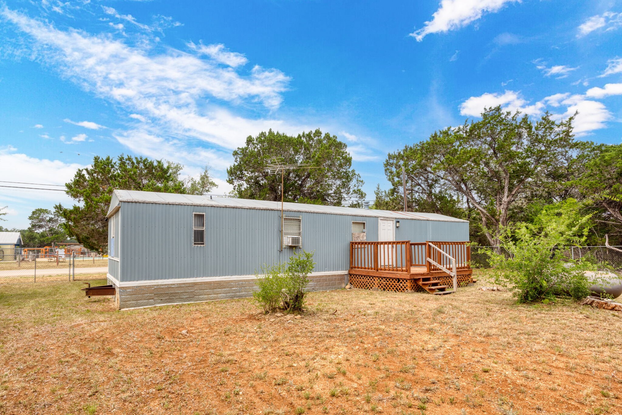 7075 Whartons Dock Road Bandera, TX 78003 - Photo 15 of 19 a backyard of a house with table and chairs